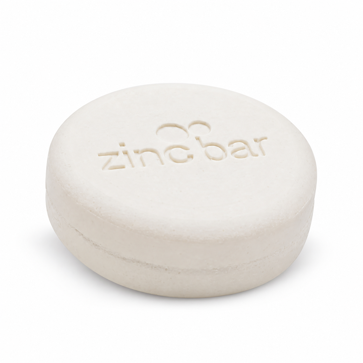 DermaHarmony Pyrithione Zinc 2% Face & Body Cleansing Bar 113 g - A single white round soap bar with an imprint