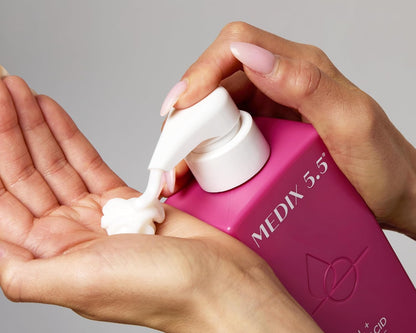 Medix 5.5 Retinol + Ferulic Acid Body Cream - Person pumping cream into their hand