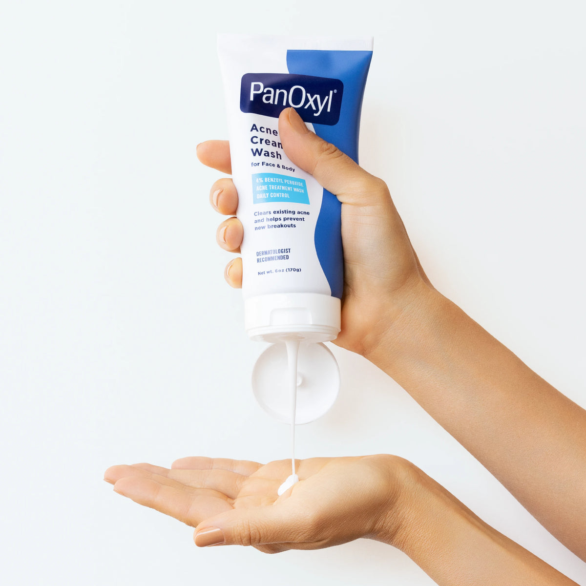PanOxyl 4% Benzoyl Peroxide Acne Creamy Wash 6 oz being dispensed into a hand